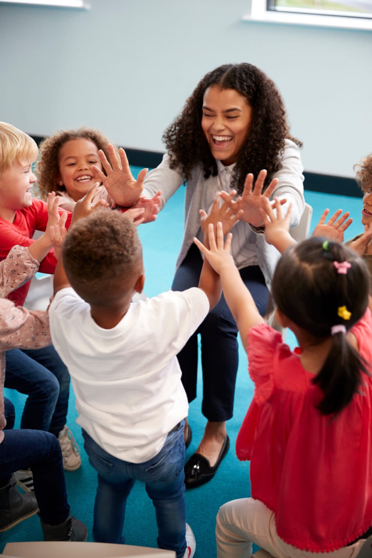 A Blue Skies Exploration Academy teacher reading with children